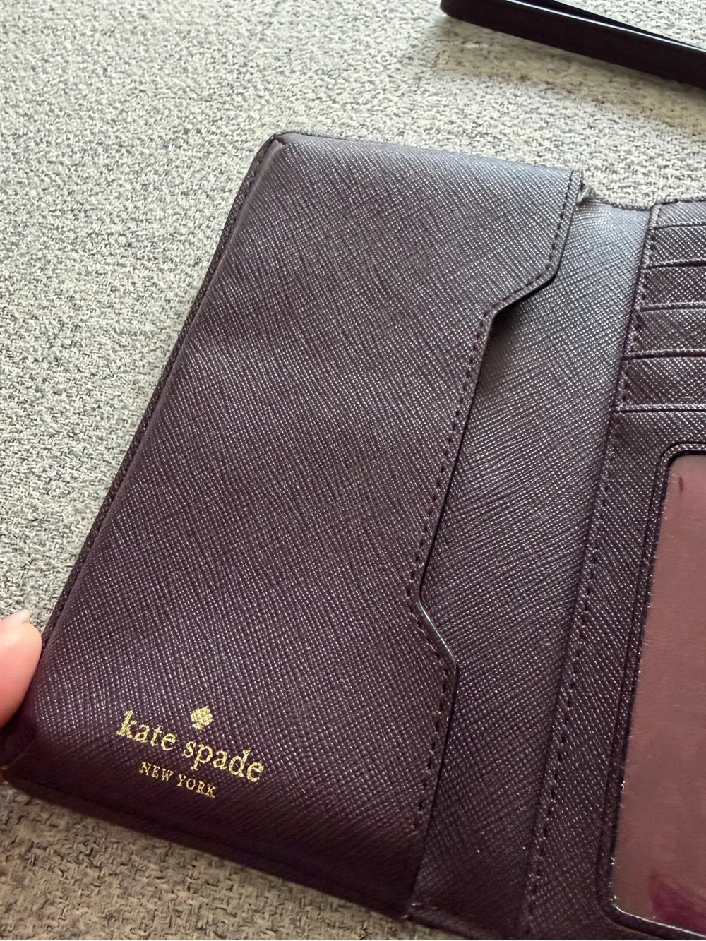 kate spade plum leather wristlet with gold-tone logo